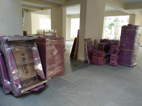 Packed Household Goods offloaded in Society & ready to load in vehicle by Delegate Movers and Packers