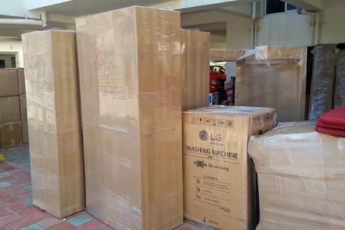 Packed Household Goods offloaded in Society & ready to load in vehicle by Delegate Movers and Packers